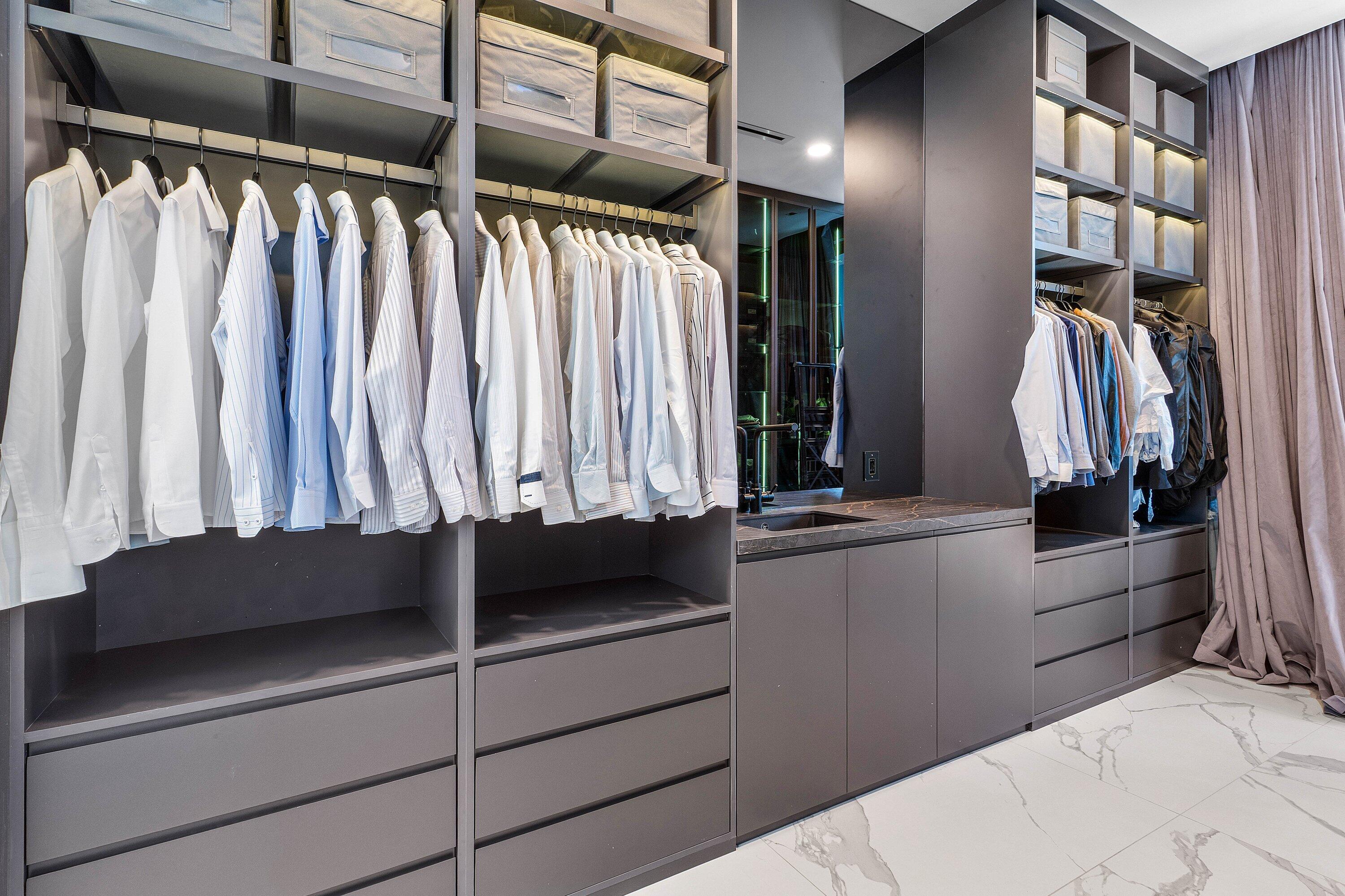 245 Northeast 6th Court Boca Raton, FL 33432 - Photo 27 of 84 a view of walk in closet with clothes and shoes