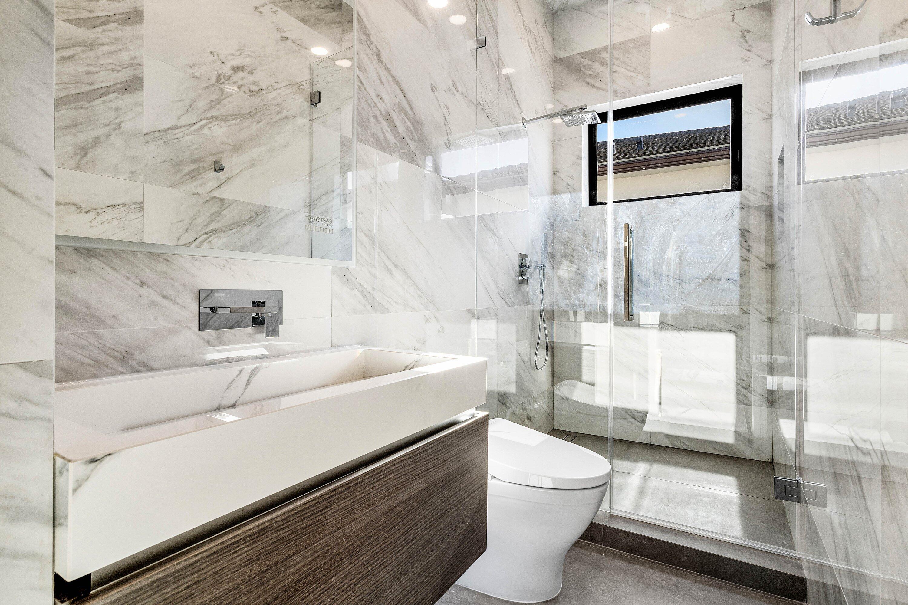 245 Northeast 6th Court Boca Raton, FL 33432 - Photo 36 of 84 a bathroom with a sink a toilet and shower