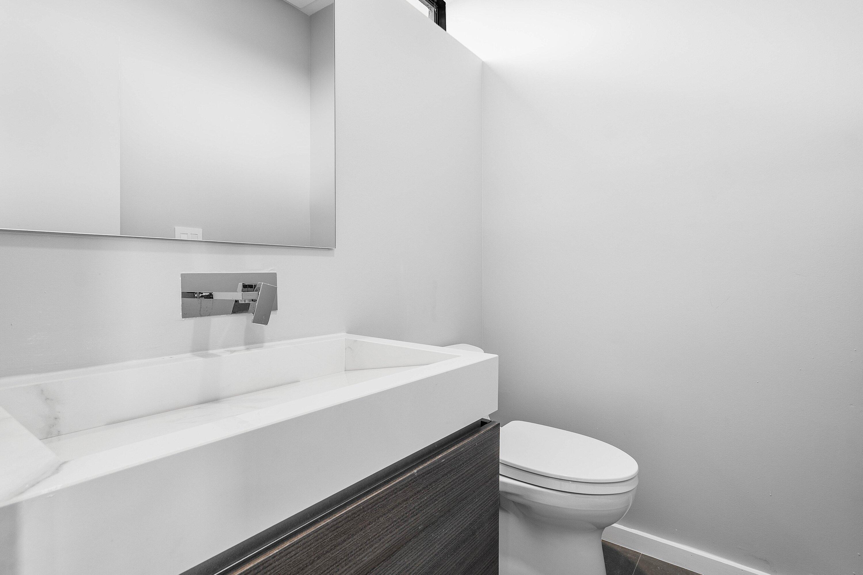 245 Northeast 6th Court Boca Raton, FL 33432 - Photo 42 of 84 a bathroom with a sink a toilet and vanity