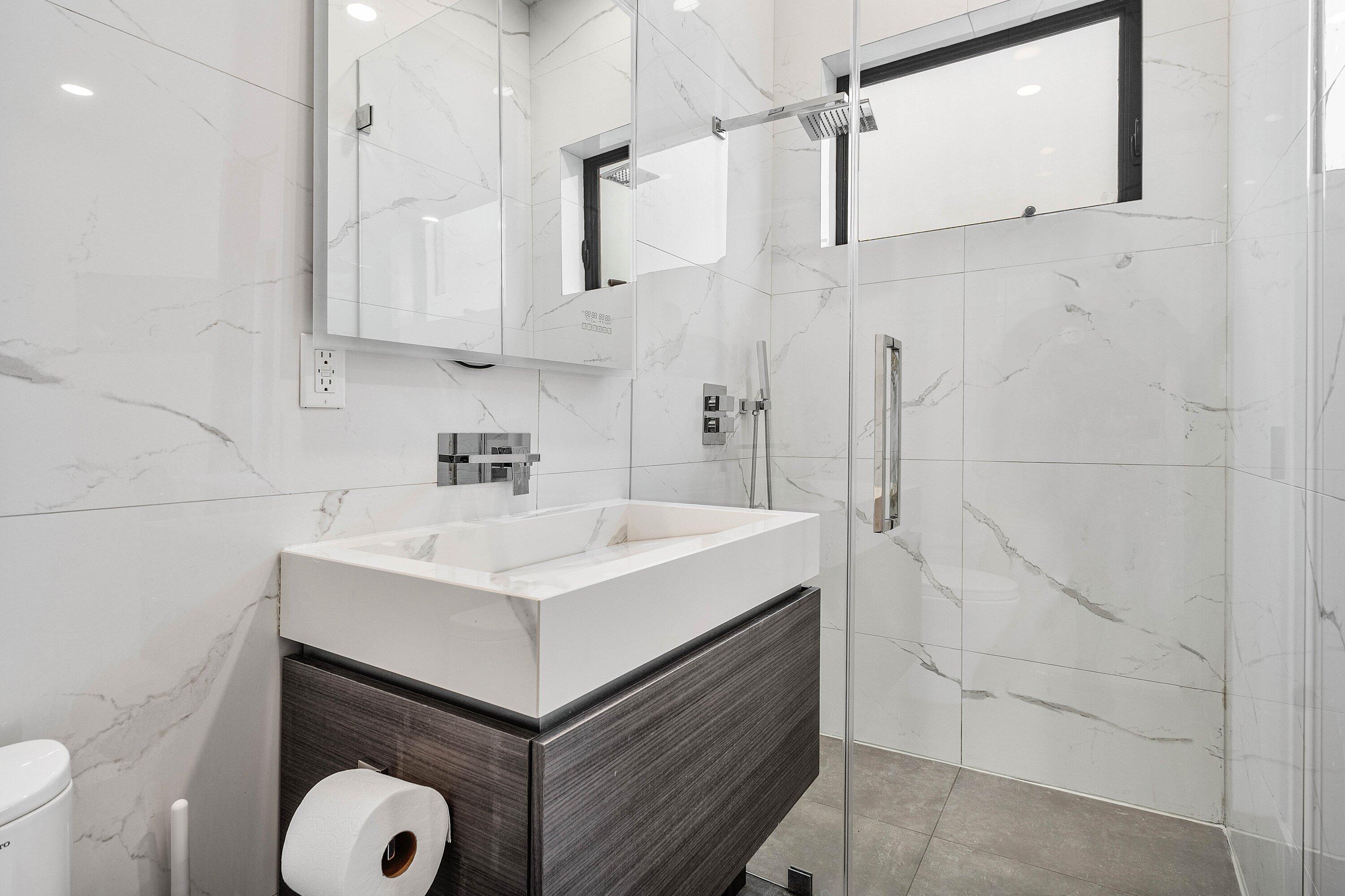 245 Northeast 6th Court Boca Raton, FL 33432 - Photo 44 of 84 a bathroom with a sink toilet and vanity