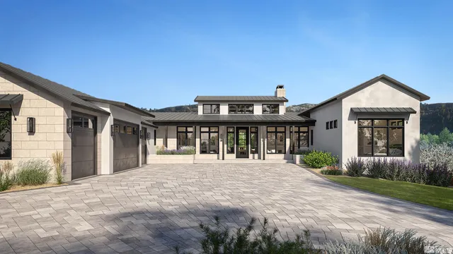 a front view of a house with a yard and potted plants