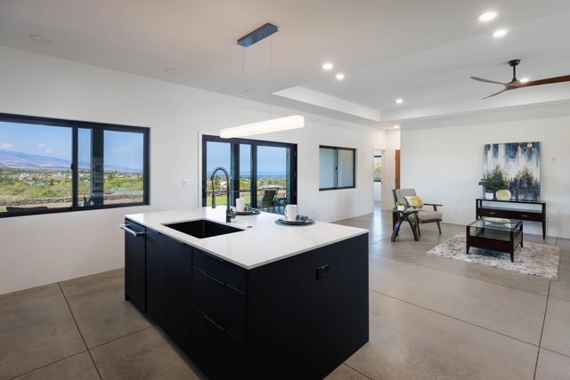 a kitchen with kitchen island a sink and a stove