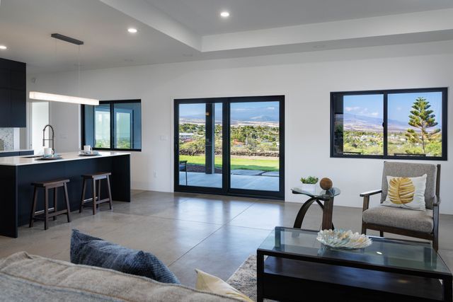 a living room with furniture and large windows