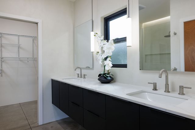 a bathroom with a double vanity sink and a mirror