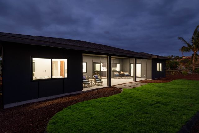 a backyard of a house with table and chairs