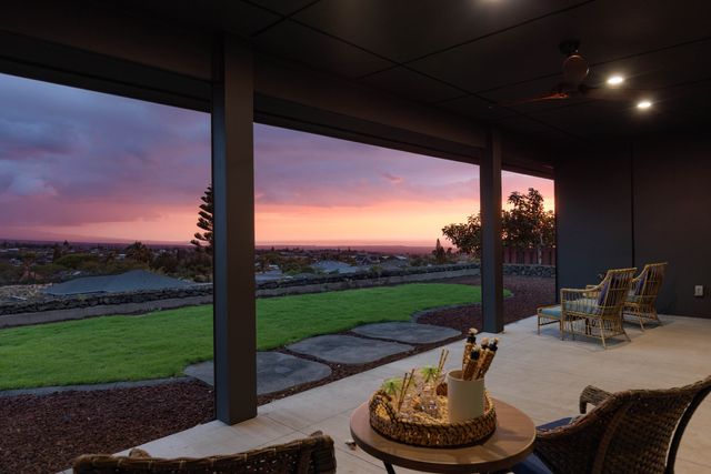 a view of a porch with furniture and a fire pit
