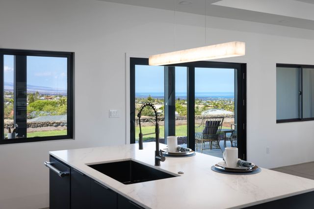 a kitchen with a sink and a large window