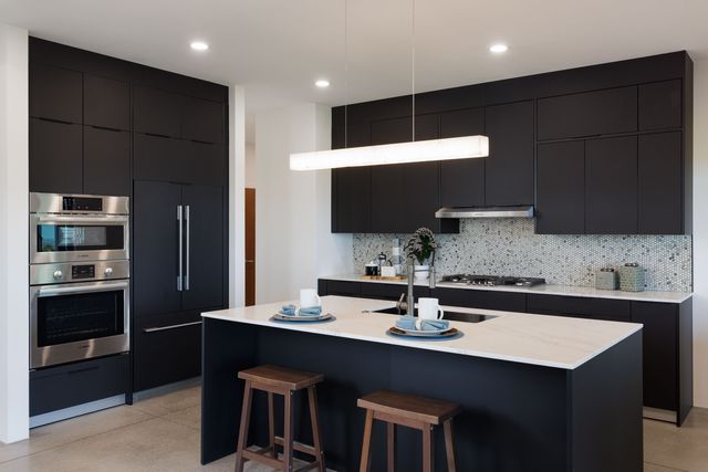 a kitchen with a sink and cabinets