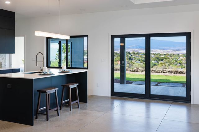 a kitchen with a sink and a large window