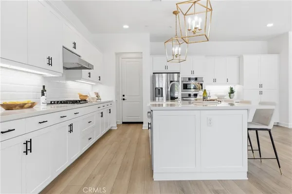 a dining room with furniture and view of kitchen
