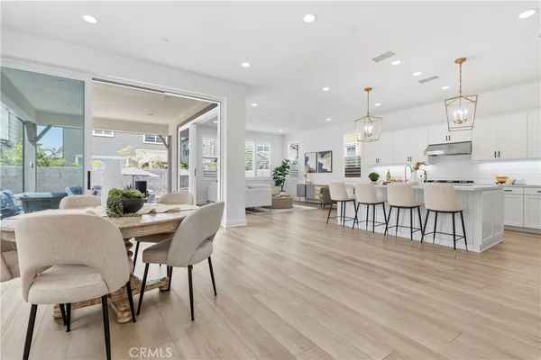 a dining room with furniture and wooden floor