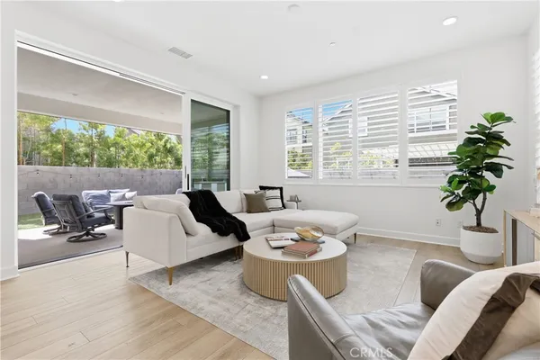 a living room with furniture a rug and a window