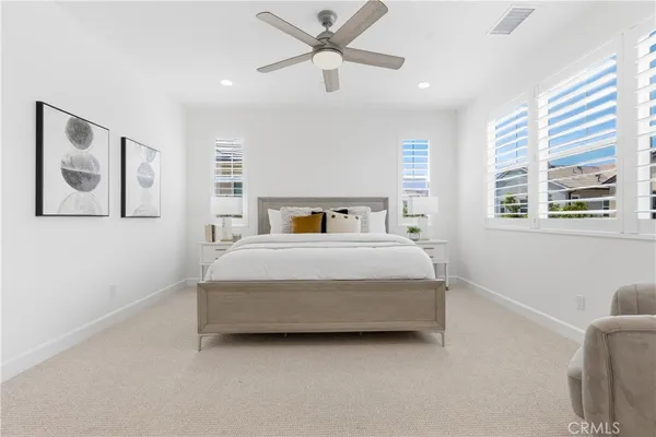 a living room with furniture a flat screen tv and kitchen view