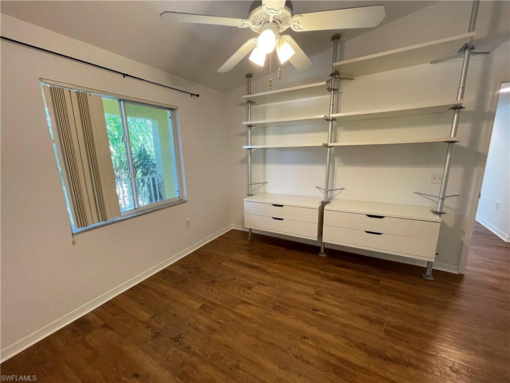 8234 Key Royal Circle, Unit 533 Naples, FL 34119 - Photo 11 of 24 a view of an empty room with a window and wooden floor