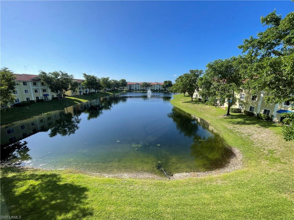8234 Key Royal Circle, Unit 533 Naples, FL 34119 - Photo 15 of 24 a view of a lake from a yard
