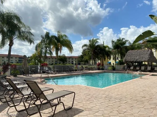 a view of a swimming pool and lounge chairs