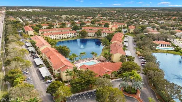 an aerial view of residential houses with outdoor space and lake view
