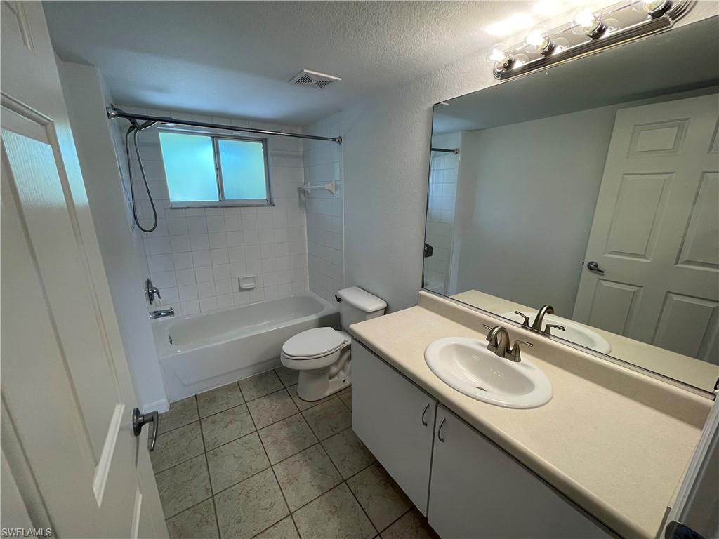 8234 Key Royal Circle, Unit 533 Naples, FL 34119 - Photo 9 of 24 a bathroom with a sink a toilet and bathtub