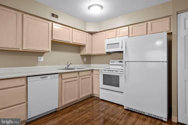 a kitchen with stainless steel appliances granite countertop a refrigerator sink and cabinets