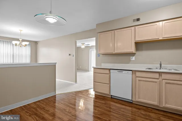 a kitchen with granite countertop a white cabinets and sink