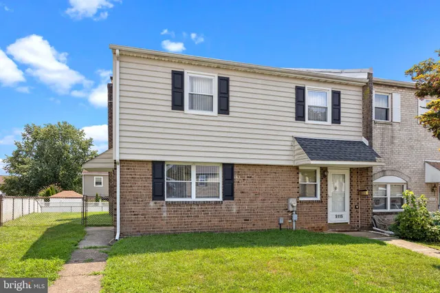 a front view of a house with a garden and yard