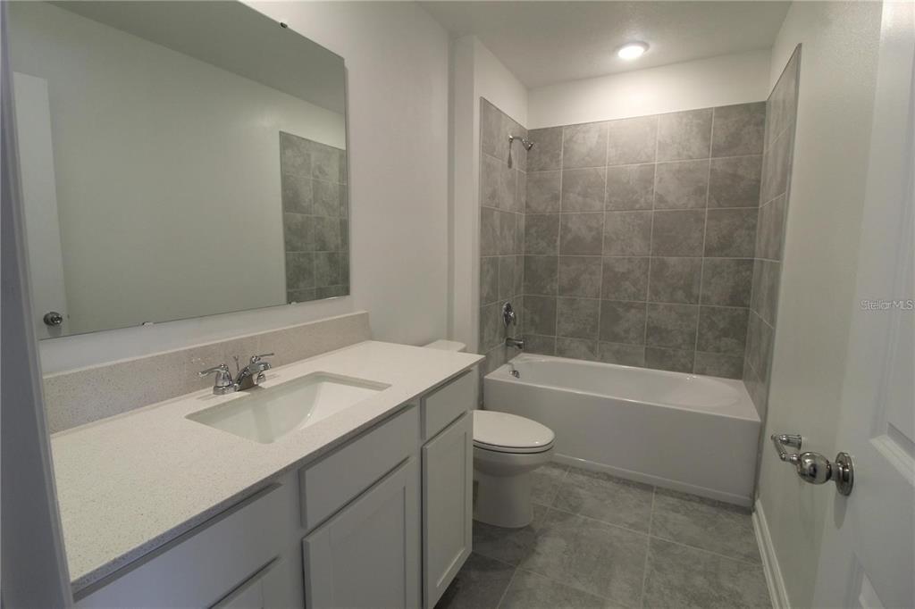 263 Hayley Street Lake Wales, FL 33859 - Photo 11 of 22 a bathroom with a sink a toilet and shower