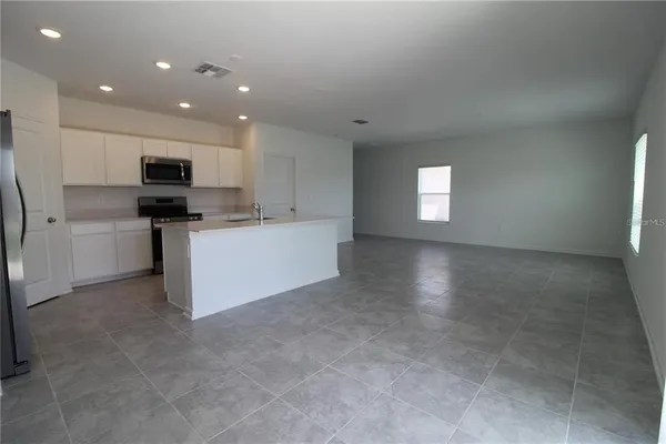 a view of a kitchen with a sink and a refrigerator