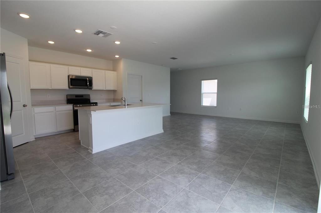 263 Hayley Street Lake Wales, FL 33859 - Photo 2 of 22 a view of a kitchen with a sink and a refrigerator