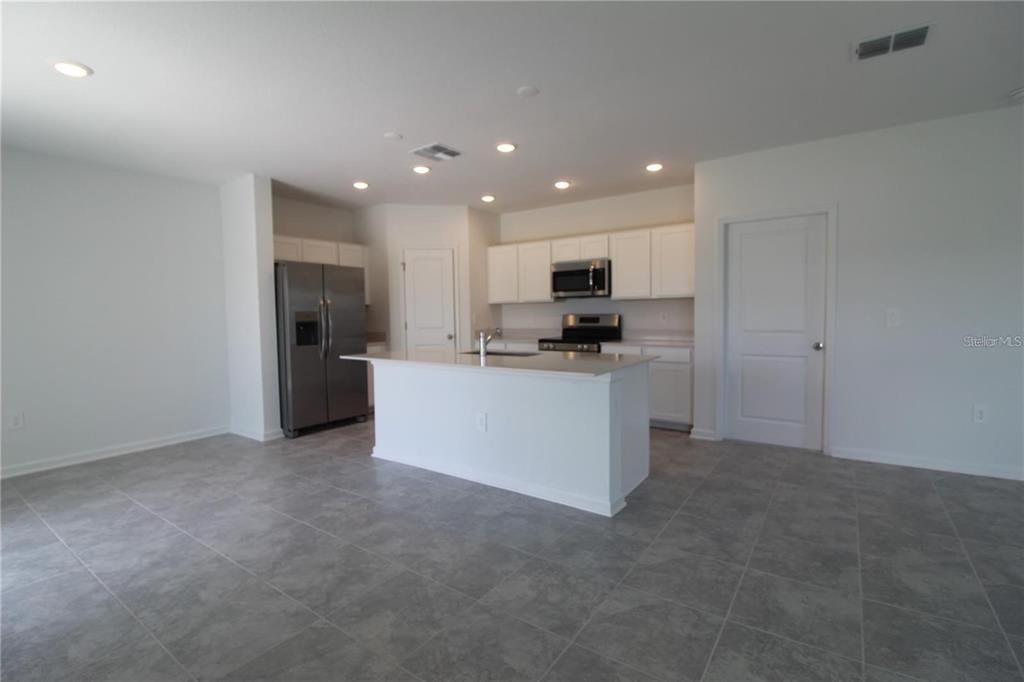 263 Hayley Street Lake Wales, FL 33859 - Photo 3 of 22 a view of a kitchen with a sink stove and cabinets