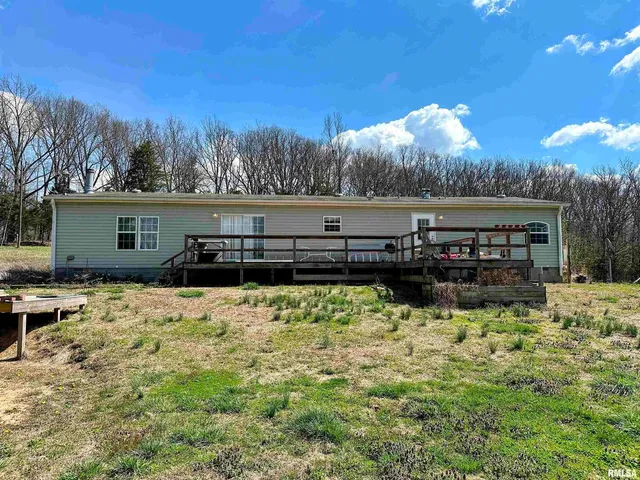 a view of a house with a yard covered with snow in the background