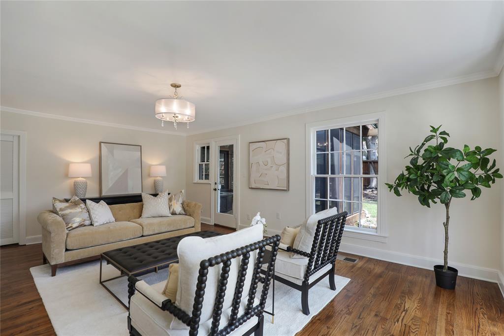 1102 Howell Street McKinney, TX 75069 - Photo 15 of 40 Large living room overlooking one of two breathtaking bay windows. Sunroom (closed in porch) attached.