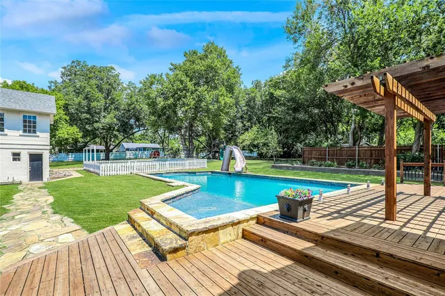 a view of a chairs and table on the wooden deck