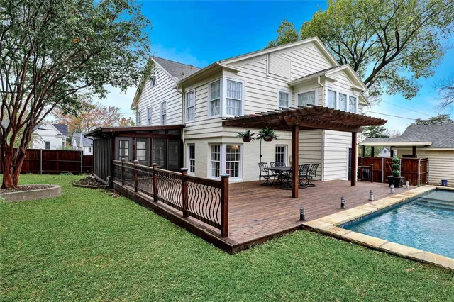 a view of a house with a yard patio and swimming pool
