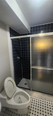 a white toilet sitting next to a bathroom sink