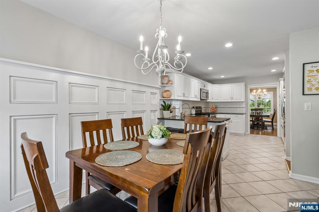 1 Beekman Hill Road Caldwell, NJ 07006 - Photo 13 of 37 a view of a dining room with furniture a chandelier and wooden floor