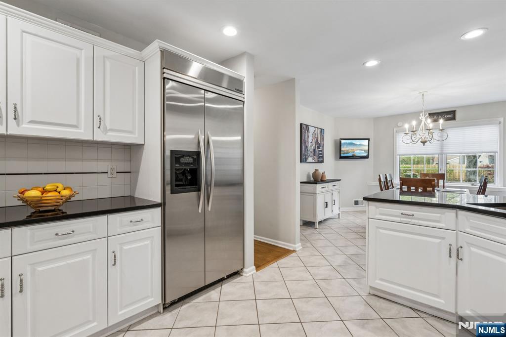 1 Beekman Hill Road Caldwell, NJ 07006 - Photo 16 of 37 a kitchen with white cabinets and white appliances