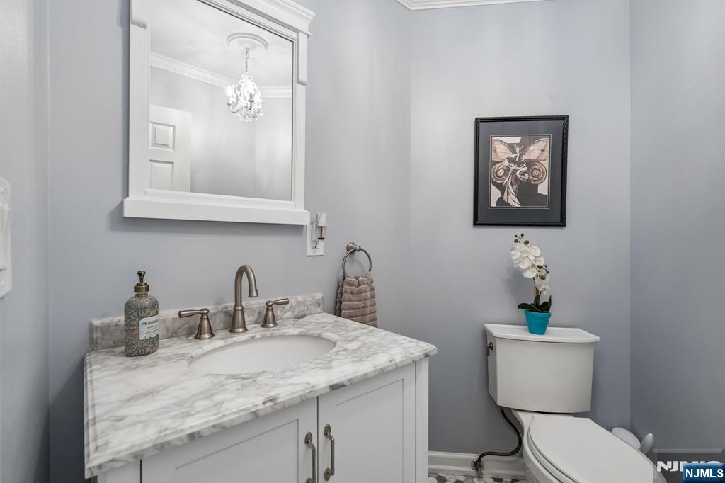 1 Beekman Hill Road Caldwell, NJ 07006 - Photo 17 of 37 a bathroom with a granite countertop sink a toilet and mirror