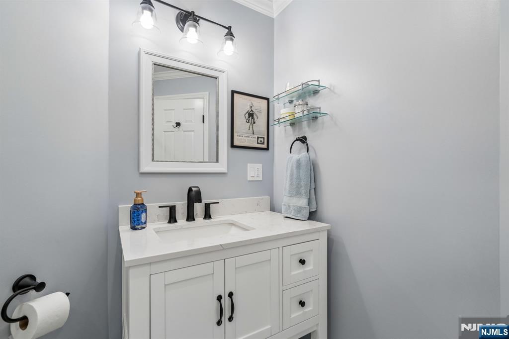 1 Beekman Hill Road Caldwell, NJ 07006 - Photo 22 of 37 a bathroom with a sink vanity and a mirror