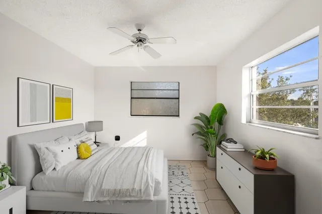 a bedroom with a bed and a window