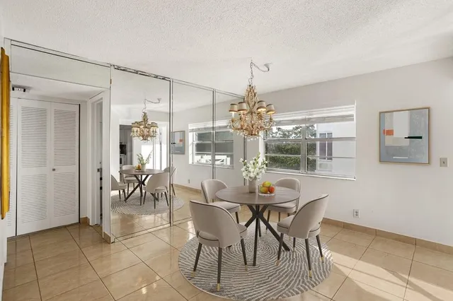 a view of a dining room with furniture and chandelier