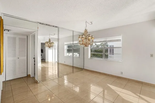 a view of a big room with windows and chandelier