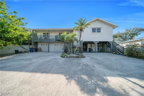 a view of a house with a yard and tree s