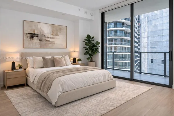 a bedroom with a large bed and a window