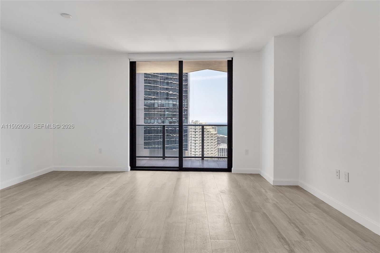 45 Southwest 9th Street, Unit 3502 Miami, FL 33130 - Photo 11 of 46 wooden floor in an empty room with a window