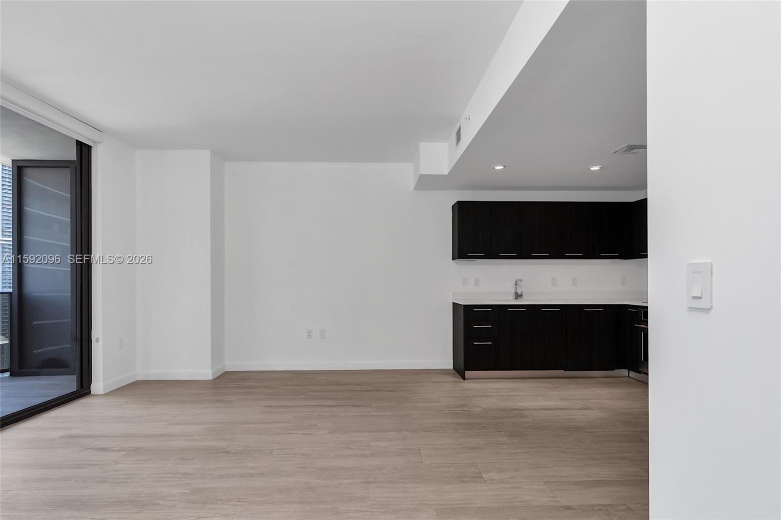 45 Southwest 9th Street, Unit 3502 Miami, FL 33130 - Photo 13 of 46 a view of an empty room with a fireplace and a flat screen tv