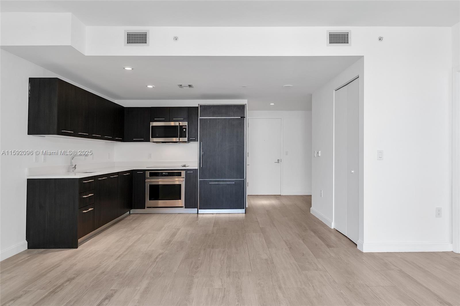 45 Southwest 9th Street, Unit 3502 Miami, FL 33130 - Photo 15 of 42 a spacious bedroom with a bed and a flat screen tv