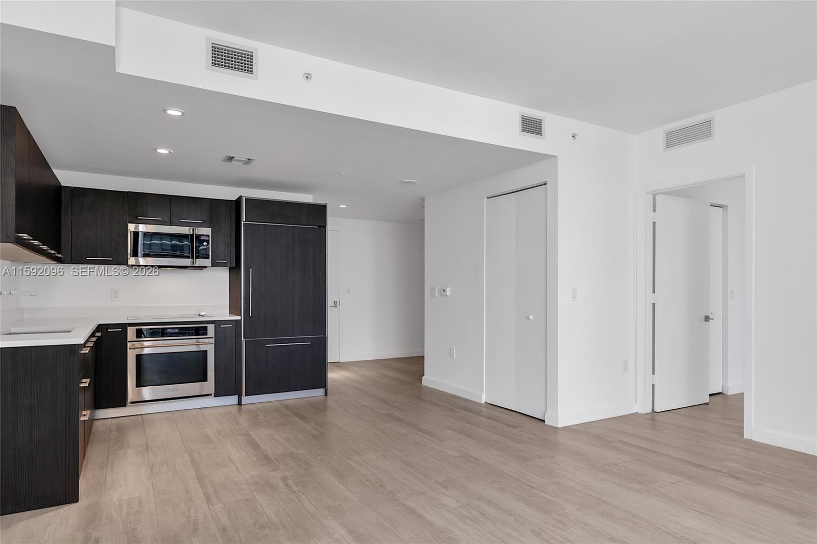 45 Southwest 9th Street, Unit 3502 Miami, FL 33130 - Photo 20 of 46 a view of a kitchen with a sink and a refrigerator