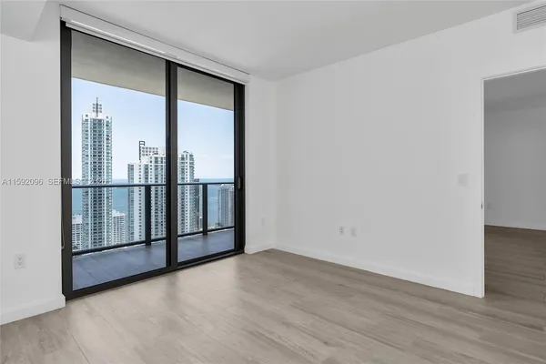 an empty room with wooden floor and door