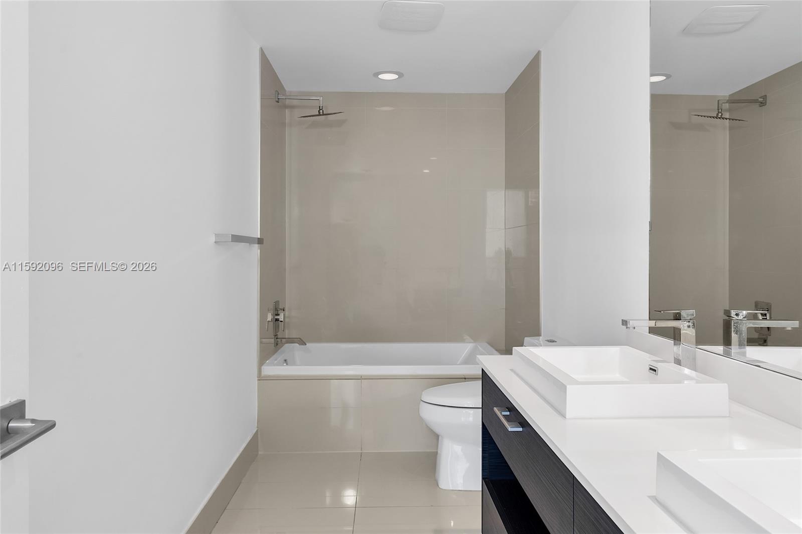 45 Southwest 9th Street, Unit 3502 Miami, FL 33130 - Photo 29 of 46 a bathroom with a sink a toilet and shower