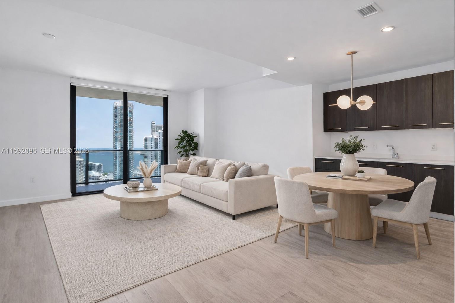 45 Southwest 9th Street, Unit 3502 Miami, FL 33130 - Photo 3 of 46 a living room with furniture and a large window